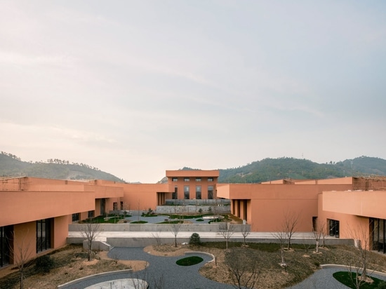 David Chipperfield embeds red natural-history museum into sloping earth