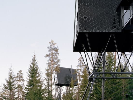 Espen Surnevik elevates pair of treetop cabins on stilts in Norwegian forest