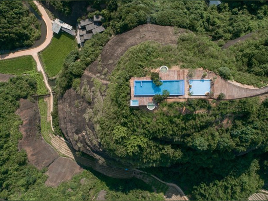 mountaintop hotel in china offers views across a landscape of rivers, forests, and hills