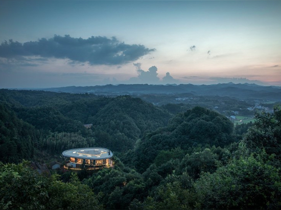 mountaintop hotel in china offers views across a landscape of rivers, forests, and hills