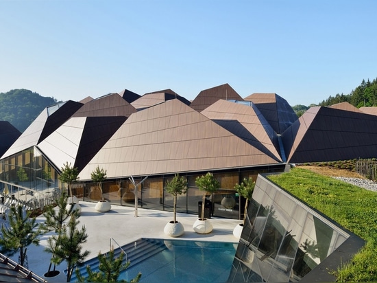 Enota encloses pool in Slovenia with geometric roof