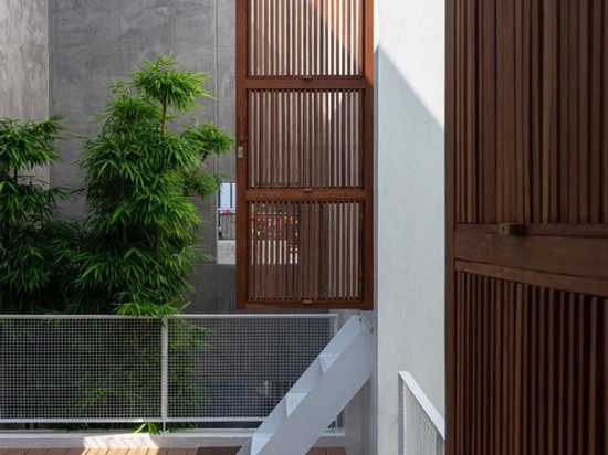 AHL encloses the living areas + courtyards of 8x24 house in vietnam using a concrete shell