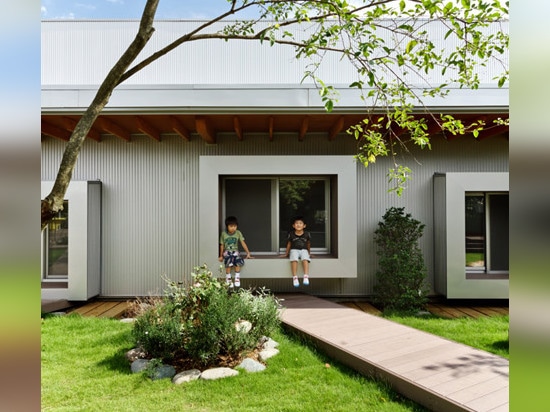 Light-filled classrooms surround a courtyard garden at DS Nursery in Japan