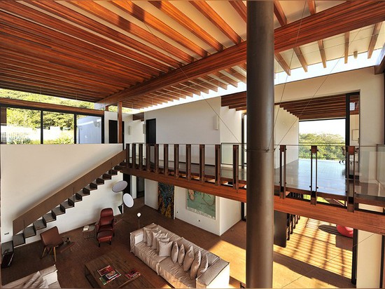 A wood lattice filters the sun, but not the views from this house in Brazil