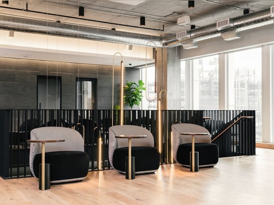 On the second level of the coworking space, individual lounge chairs with work surfaces are a grown-up version of a school desk.