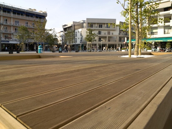 A Large Bench Serves As A Gathering Place In This Town Square