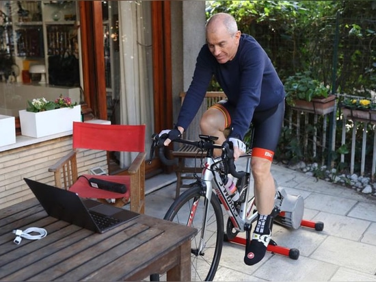 A cyclist in Italy trains at home on a stationary bike to avoid leaving his home as the country continues a nation-wide lockdown amid the Covid-19 pandemic