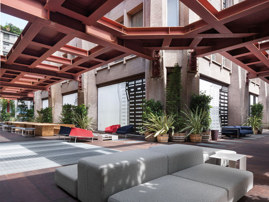 Part café lounge, part urban zen forest, the temporary terrace has a wooden deck floor surrounded by a lush curtain of vegetation, while red metal scaffolding acts as a sort of plantless pergola