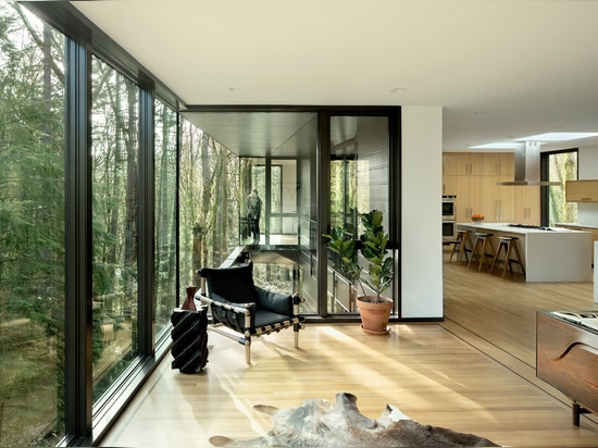 Black wood and glass volumes stagger down Oregon woodland to form Royal house