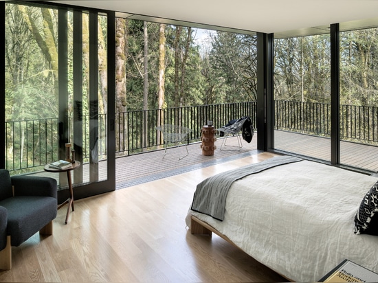 Black wood and glass volumes stagger down Oregon woodland to form Royal house