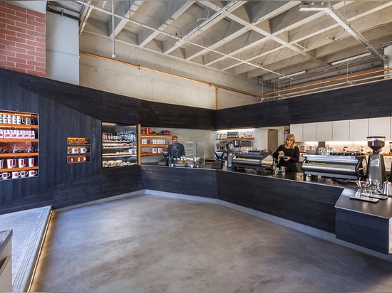 The architects' intention was to design an attractive coffee-themed space while simultaneously revitalizing this neglected part of the neighborhood, located at the entrance Saint Mary’s Garage, acr...