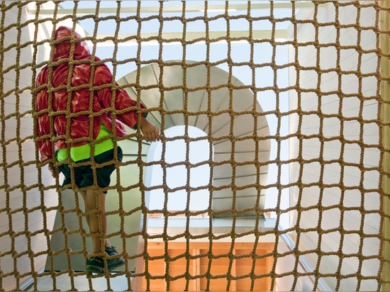 Only children and agile adults can enter, as a custom climbing rope net is the threshold to the main floor, but the fun doesn’t stop there.