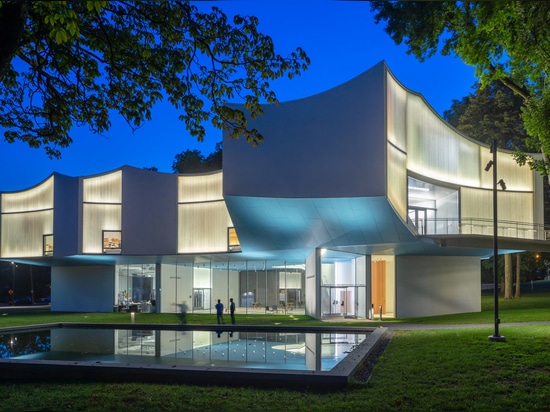 A nearby pool is designed to reflect the building