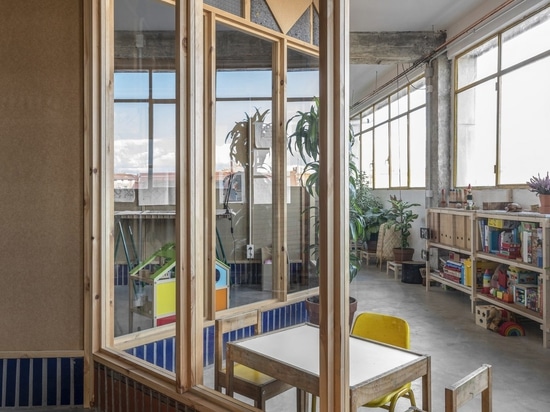 Wood and brick partitions divide the old workshop's concrete shell