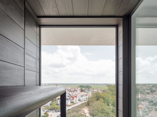 Apartment on the Belgian coast balances natural and industrial materials