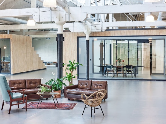 Most of the original structure of the warehouse was preserved, including wooden roof trusses and supporting steel columns.   Read more: Fairphone’s Amsterdam offices built inside an old warehouse u...