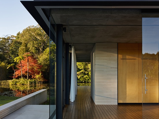 The glazed 72-square-meter pavilion features a minimalist natural materials palette comprising vertical timber slats, steel, concrete, and sandstone.   Read more: Gorgeous Miesian-inspired glass pa...