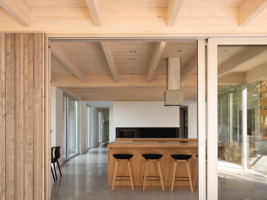 A House In The Forest Clad In Eastern Cedar Siding Is Raised Above The Surrounding Rocky Landscape