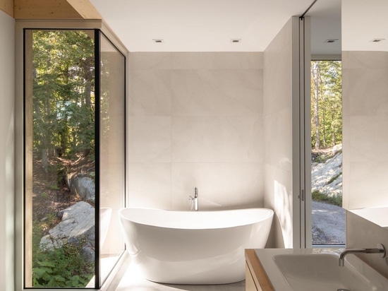 A House In The Forest Clad In Eastern Cedar Siding Is Raised Above The Surrounding Rocky Landscape