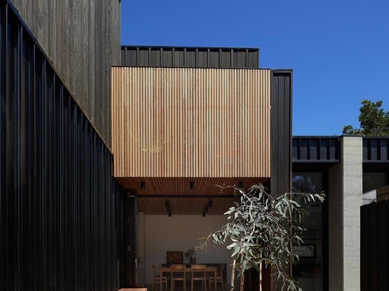 An Exterior Of Blackbutt Timber Hides The Bright White Interior Of This Home