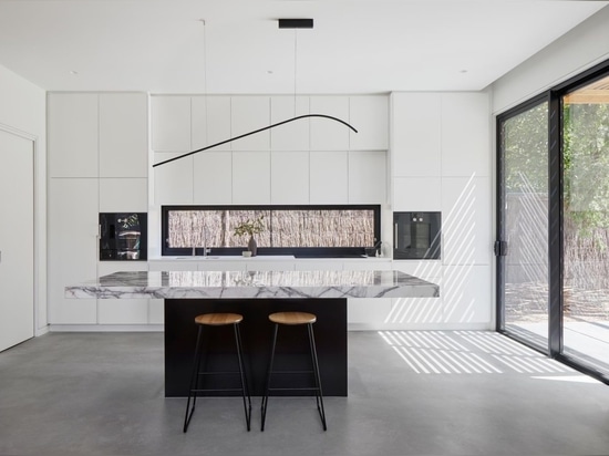 An Exterior Of Blackbutt Timber Hides The Bright White Interior Of This Home