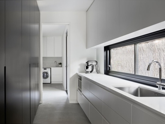 An Exterior Of Blackbutt Timber Hides The Bright White Interior Of This Home