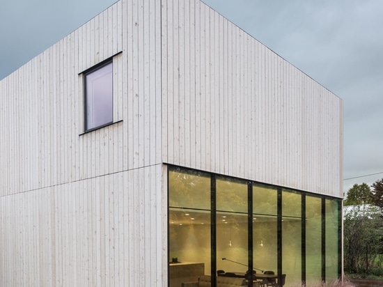 A Home Office Was Made Possible By Building A Desk Along A Wall Of Windows Inside This House