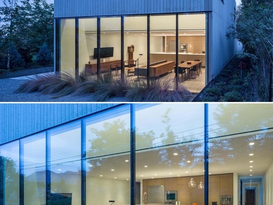 A Home Office Was Made Possible By Building A Desk Along A Wall Of Windows Inside This House