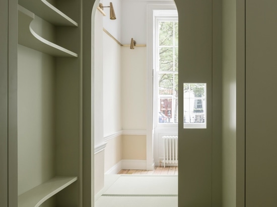 An arched doorway looks through to the master bedroom