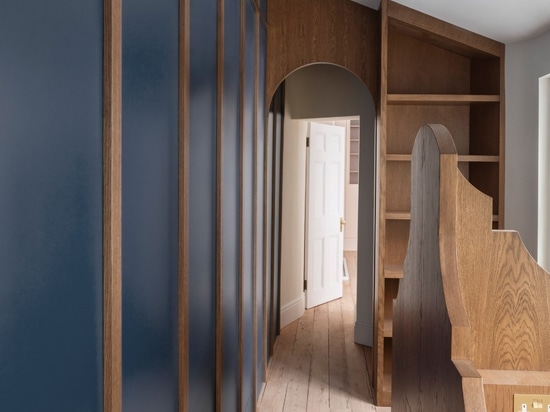 The apartment's study features contrasting blue panelling