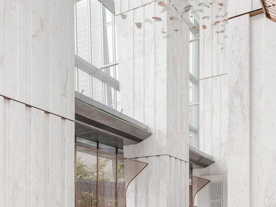 Marble-clad columns and cushioned benches line the entrance lobby