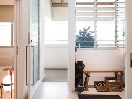 The foyer leads through into the right-hand side of the apartment, which includes a relaxed break-out area