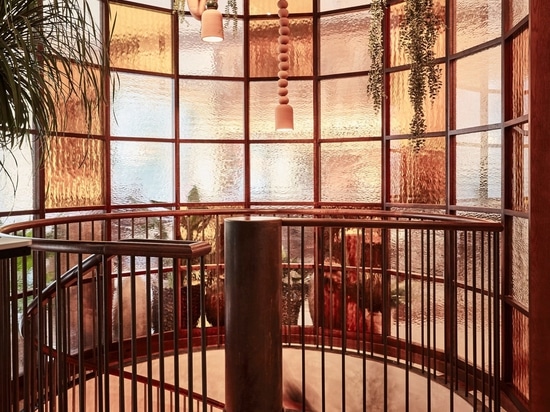 A glass screen obscures the restaurant's spiral staircase