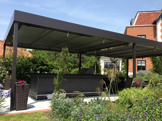 Outdoor living room with bioclimatic pergola  in a country house in England