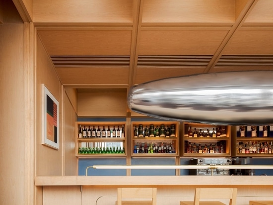 A metallic art installation hangs over the bar