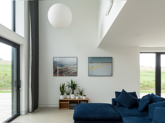 An atrium is overlooked by a first-floor balcony