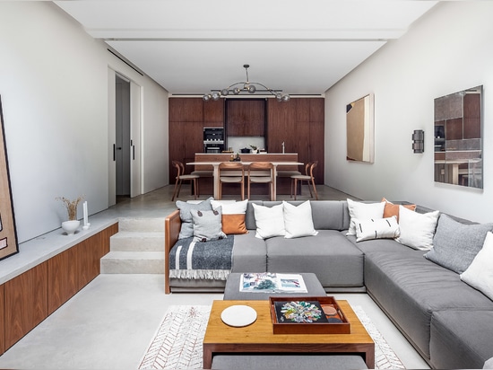 The basement level features a sunken seating area and a kitchen