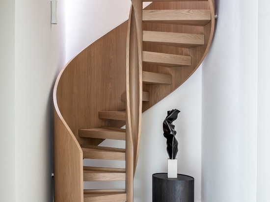 A helical staircase connects the three floors