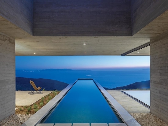 A Long Thin Swimming Pool Extends Out From This Hillside Home