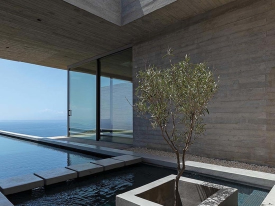 A Long Thin Swimming Pool Extends Out From This Hillside Home