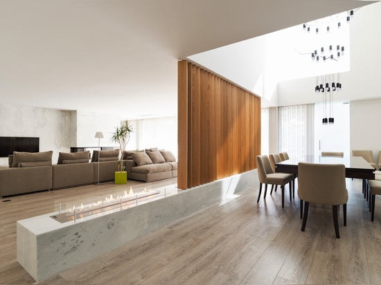 Fireplace in a natural stone finish as a room divider