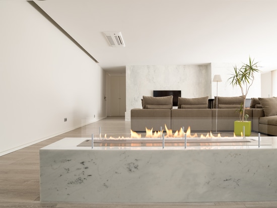 Fireplace in a natural stone finish as a room divider