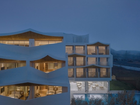 Pitched roofs span the facades of the hotel