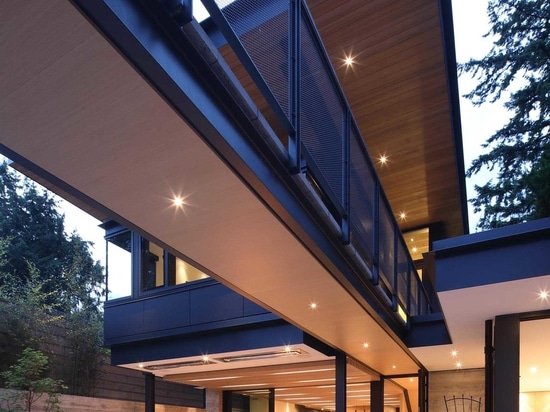 A Deep Overhanging Roof Protects This Modern House From The Rain