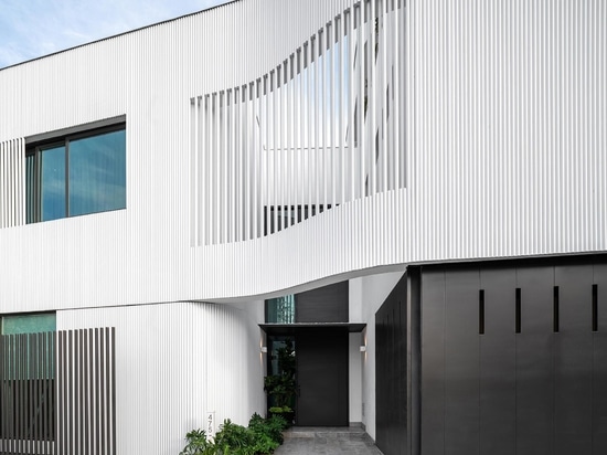 White Metal Pipes Add Texture To The Exterior Of This Home