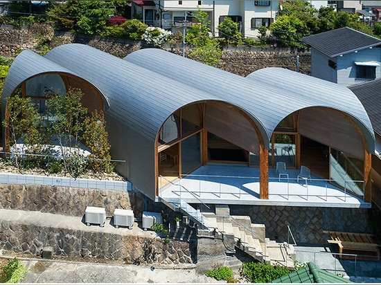 A series of tilted vaulted roofs tops wooden house by tomohiro hata in koyoen, japan