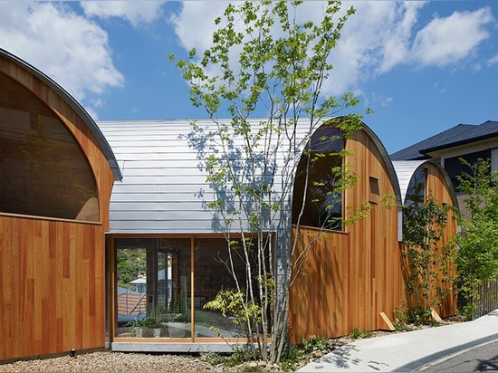 A series of tilted vaulted roofs tops wooden house by tomohiro hata in koyoen, japan