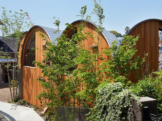 A series of tilted vaulted roofs tops wooden house by tomohiro hata in koyoen, japan