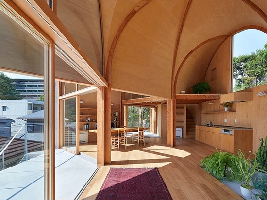 A series of tilted vaulted roofs tops wooden house by tomohiro hata in koyoen, japan