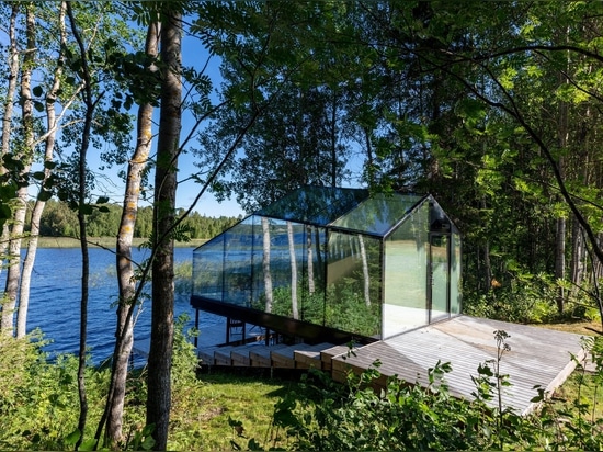 Mirrored glass cabin with panoramic views disappears into Finland's rich natural landscape